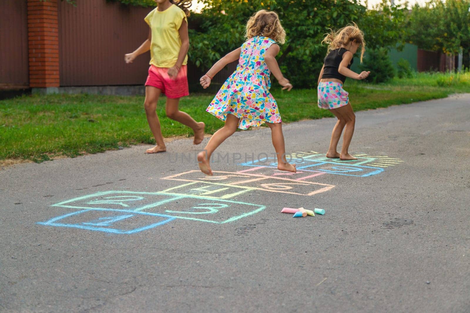 Children jumping hopscotch on the street. Selective focus. kids.