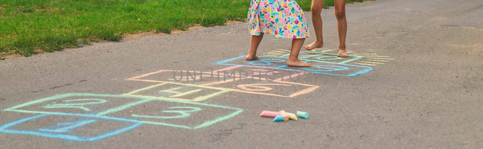 Children jumping hopscotch on the street. Selective focus. kids.