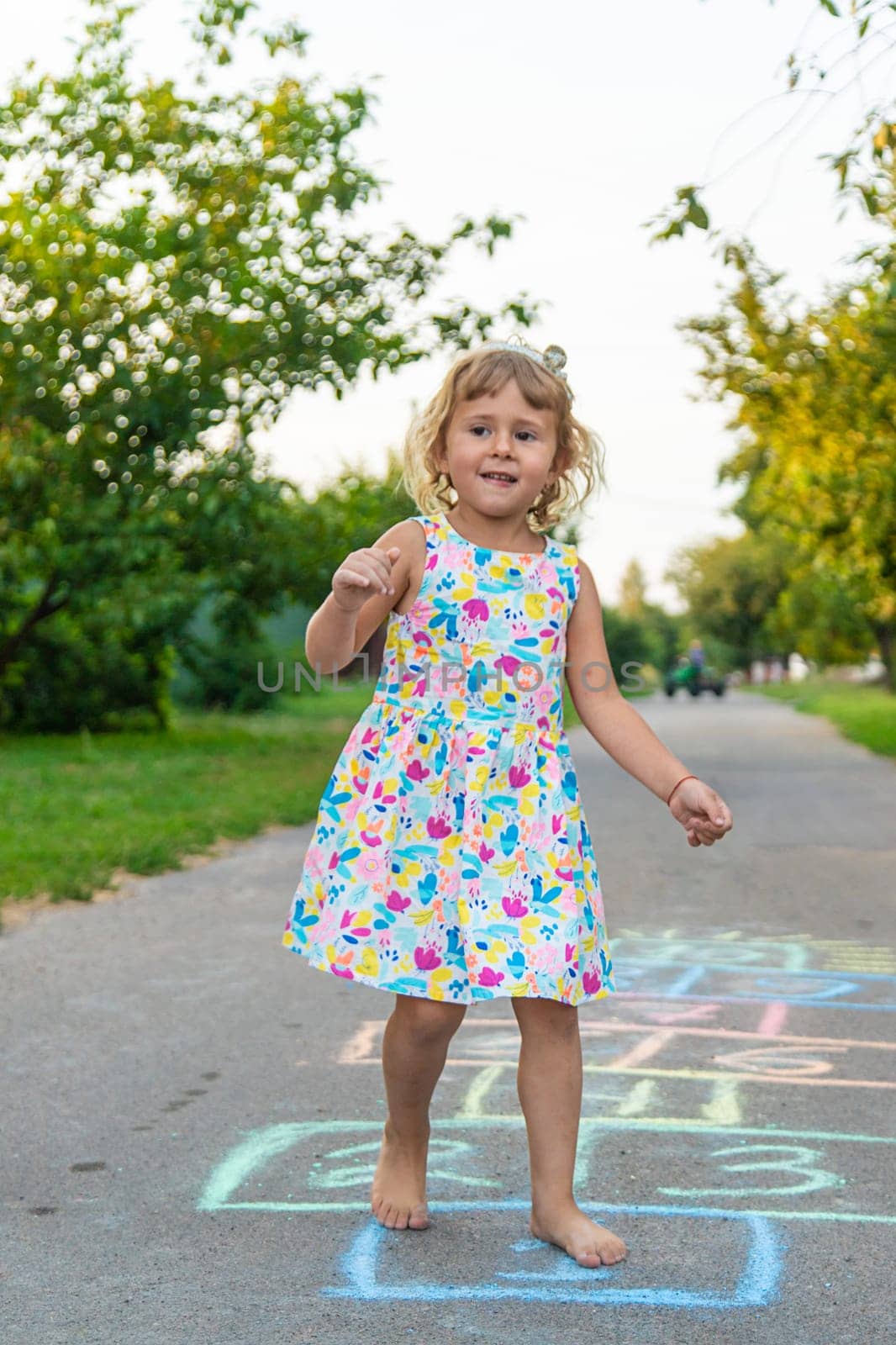 Children jumping hopscotch on the street. Selective focus. kids.