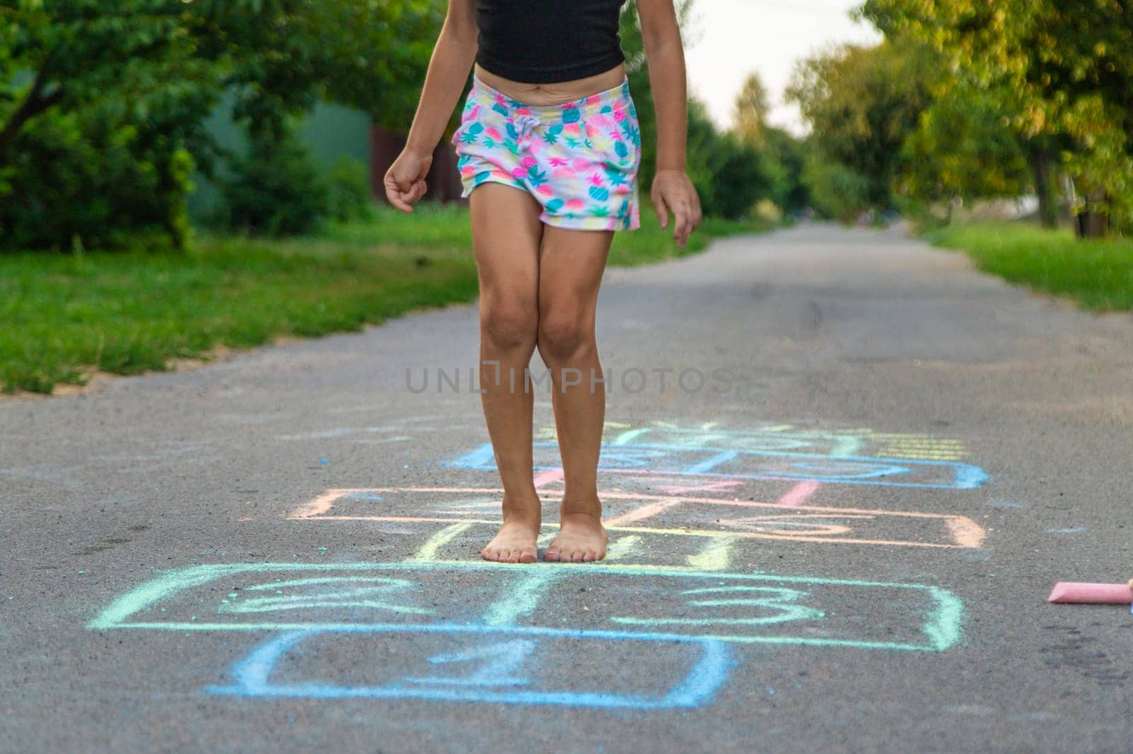 Children jumping hopscotch on the street. Selective focus. kids.