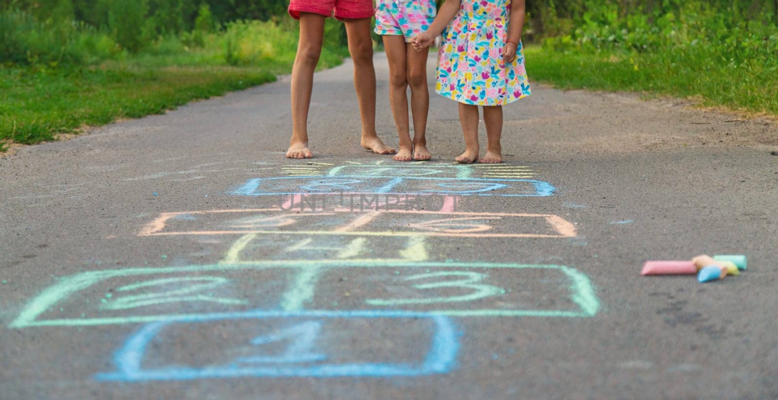 Children jumping hopscotch on the street. Selective focus. kids.
