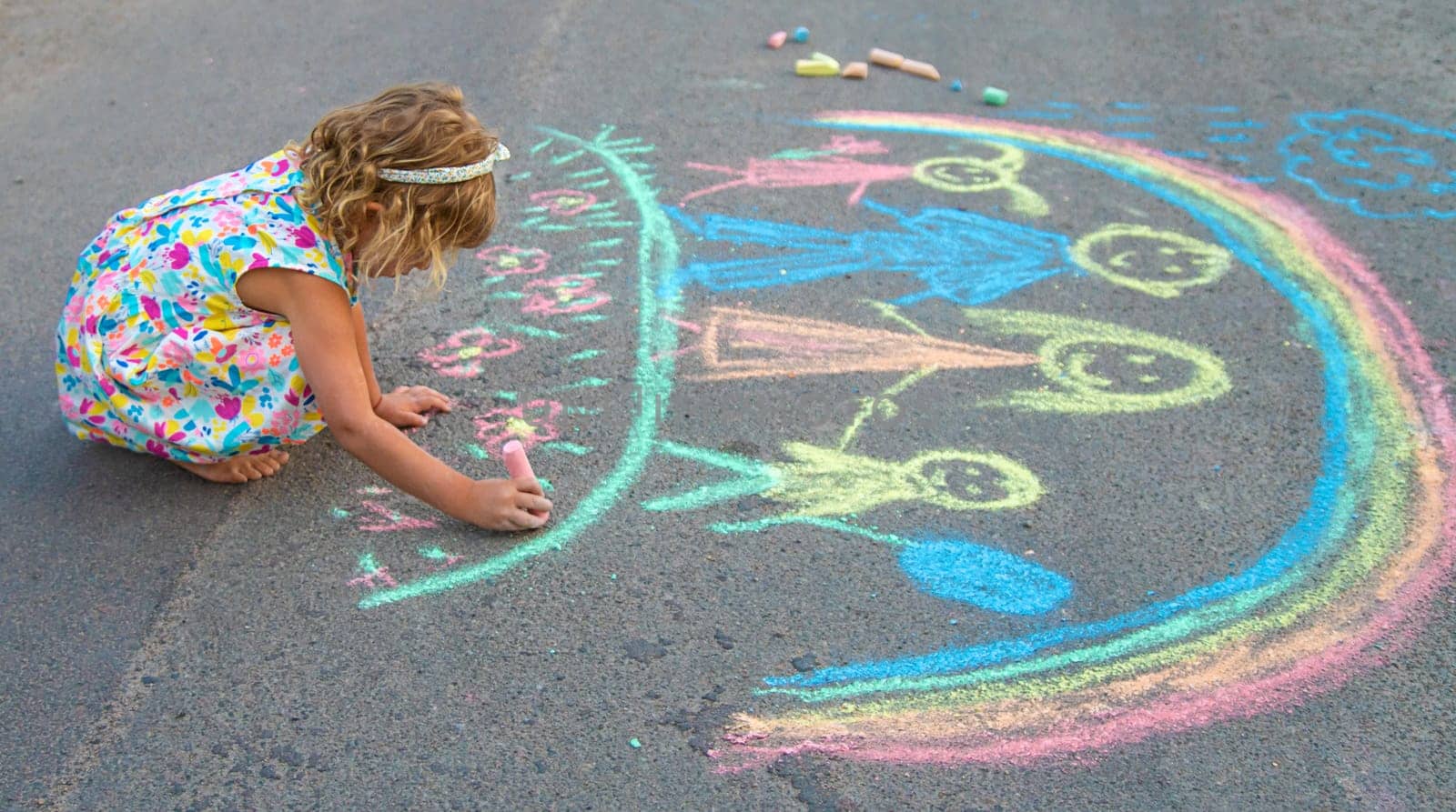 Children draw with chalk on the asphalt. Selective focus. kid.
