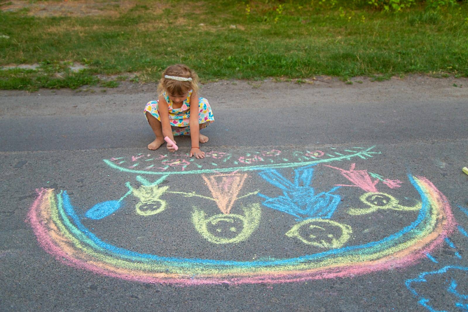 Children draw with chalk on the asphalt. Selective focus. kid.