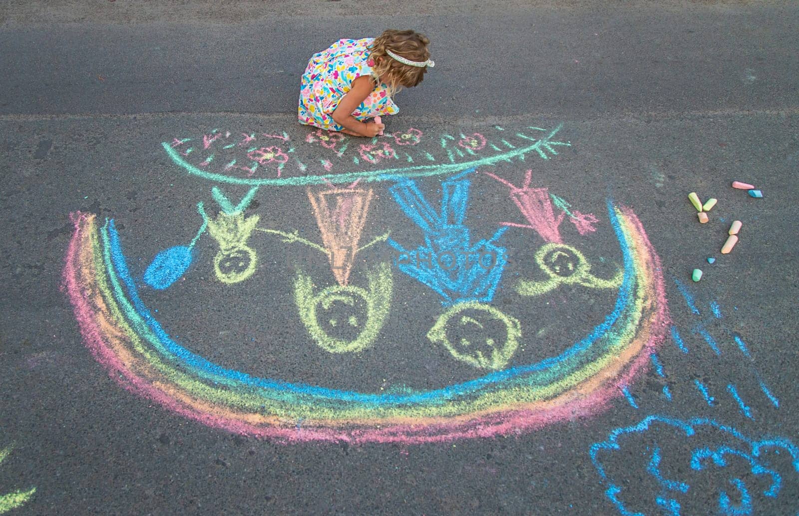 Children draw with chalk on the asphalt. Selective focus. kid.