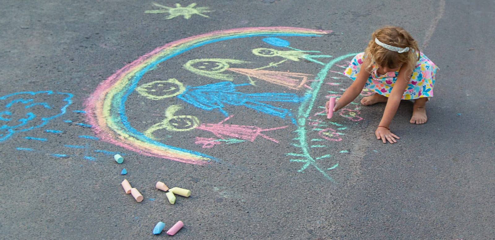 Children draw with chalk on the asphalt. Selective focus. kid.