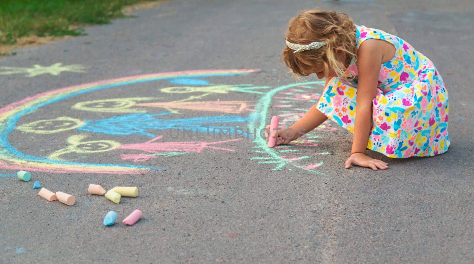 Children draw with chalk on the asphalt. Selective focus. kid.