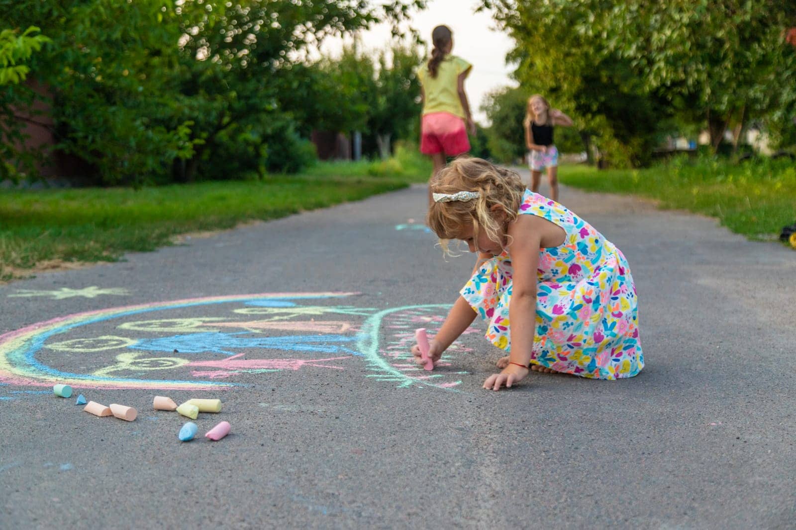 Children draw with chalk on the asphalt. Selective focus. kid.
