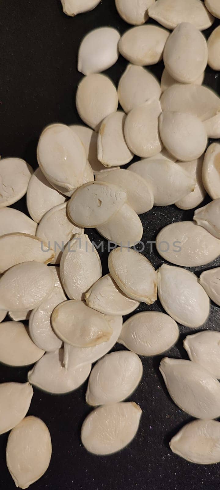 white pumpkin seeds healthy food in black pan. High quality photo