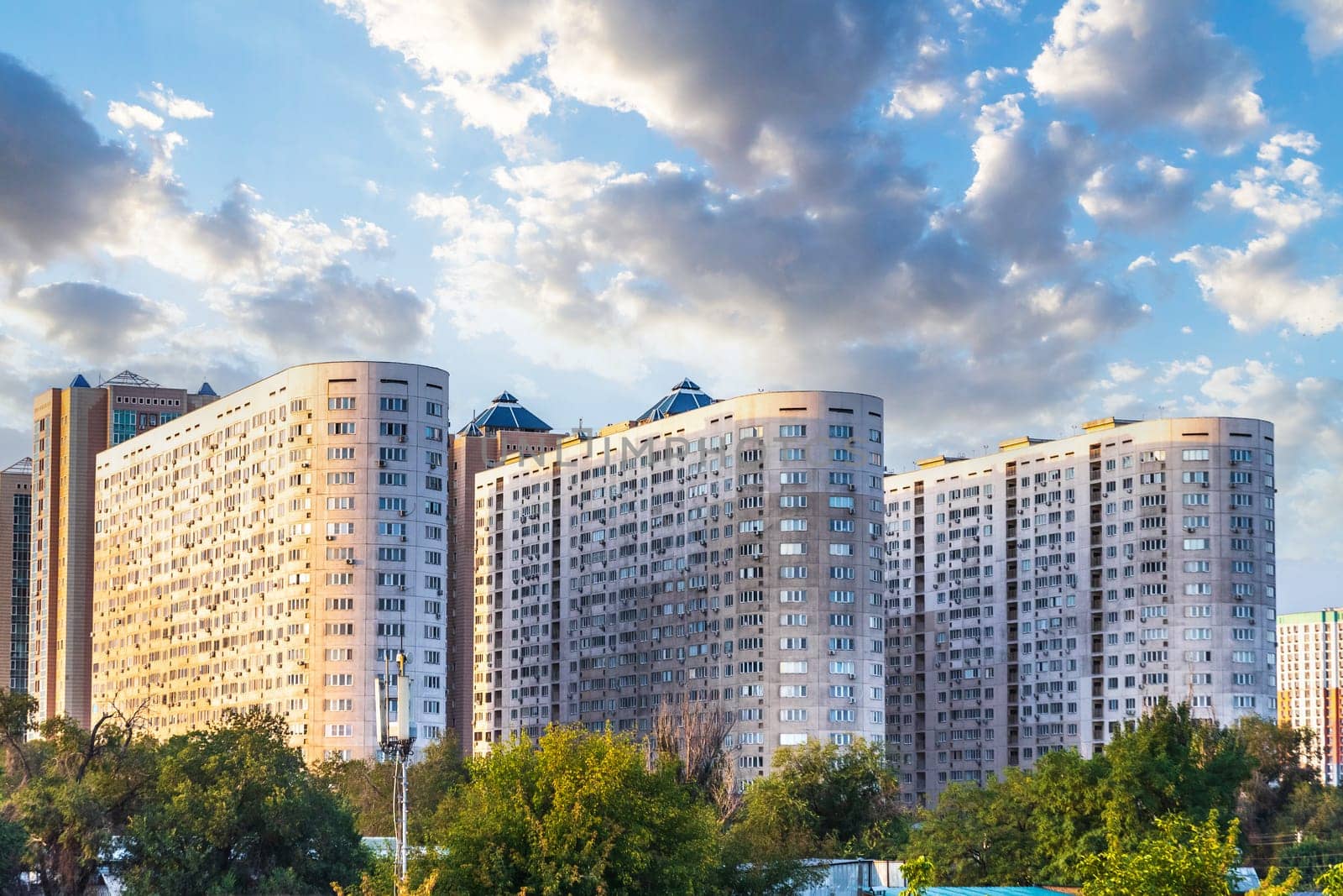 Almaty Urban Landscape: High-Rise Residential Complexes Amidst scenic sky.