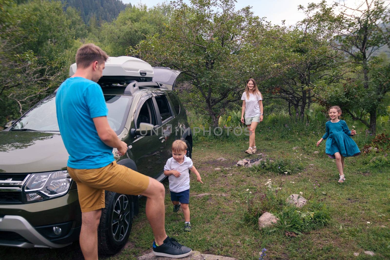 A joyful family happily enjoying quality time together outdoors, traveling in their car amidst beautiful nature