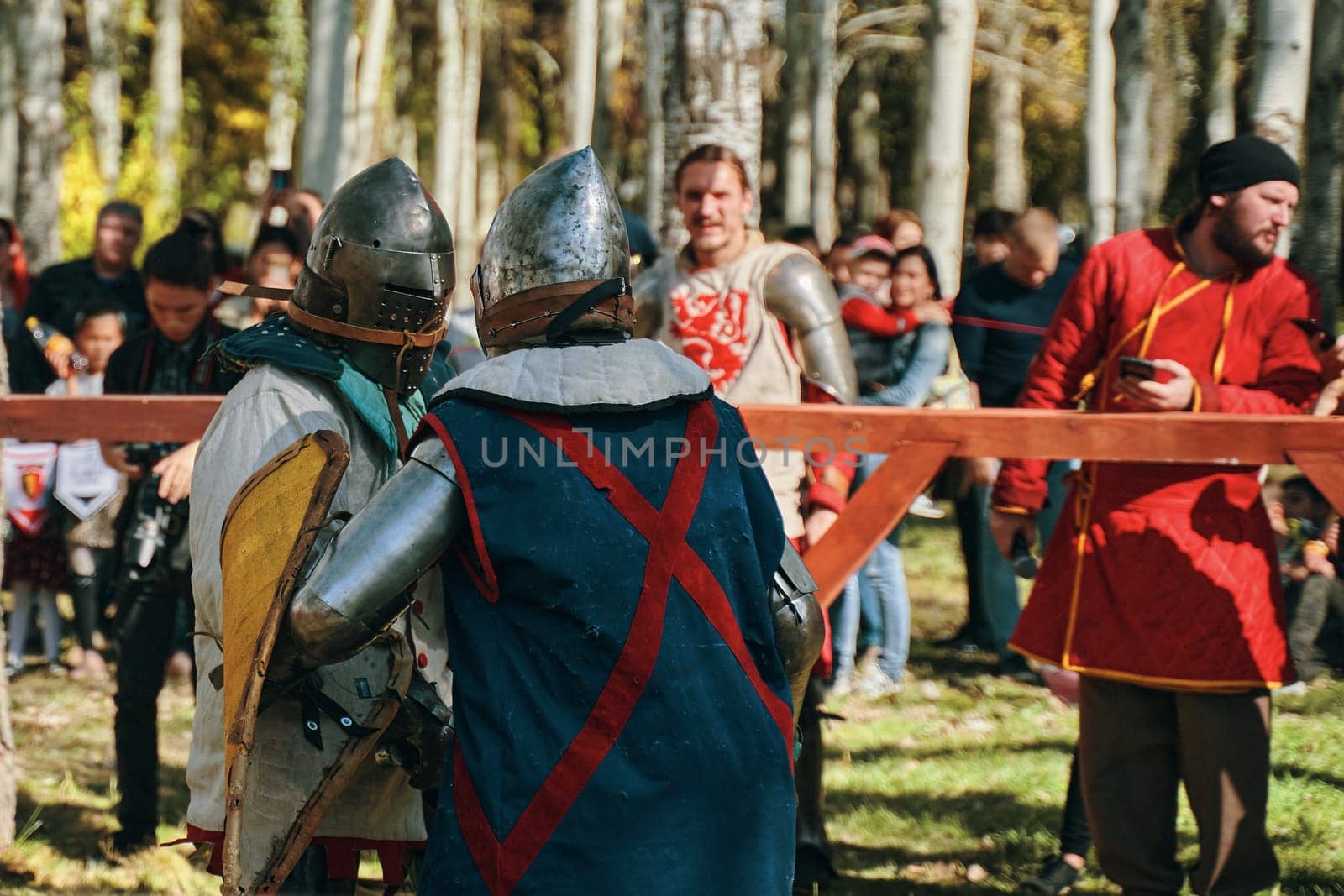 Reconstruction of medieval jousting tournaments. Knights in armor and helmets, fighting with swords and shields in the arena. Festival of historical clubs. Bishkek, Kyrgyzstan - October 13, 2019