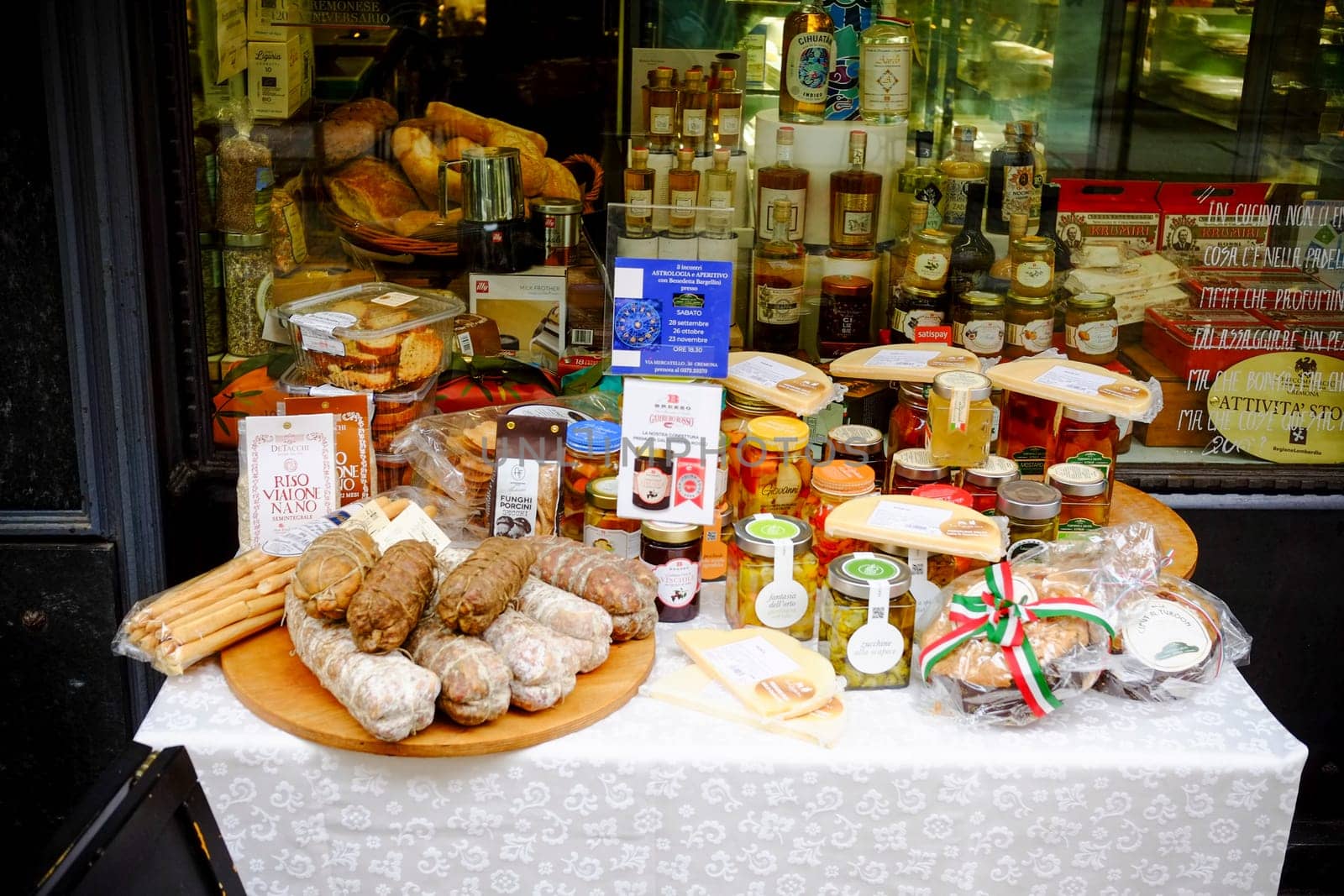 Cremona, Lombardy, Italy - November 7th 2024 Display of traditional italian food products like breadsticks, salami, preserved vegetables, and local specialties, creating an inviting scene