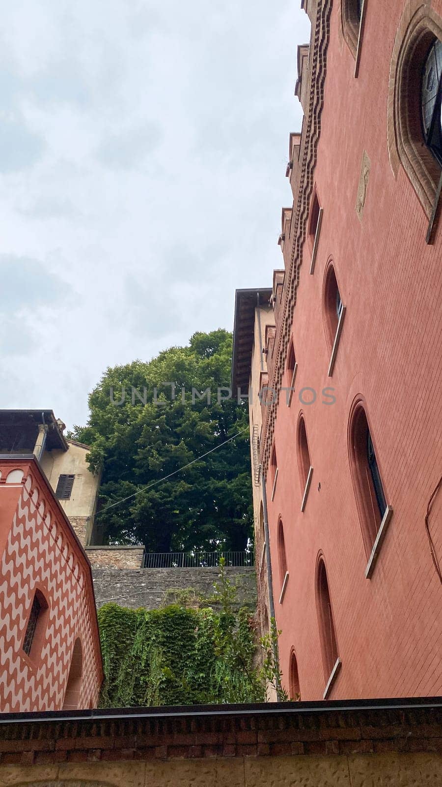 Cremona, Lombardy, Italy October 15th 2024 Bergamo alta medieval walls and buildings rising towards a cloudy sky, showcasing the city's rich history and architectural heritage