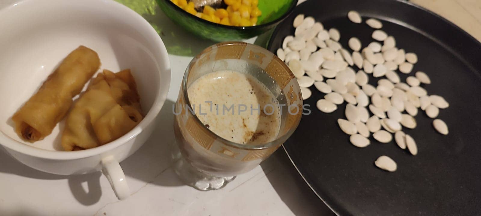 white pumpkin seeds healthy food in black pan, coffee cup. High quality photo