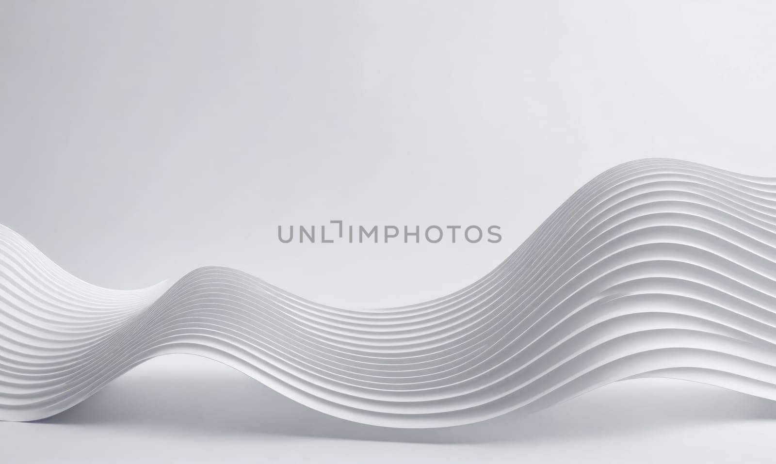 A white, abstract sculpture with a wavy shape made up of many layers. The sculpture is set against a white background, highlighting the smooth lines and curves.