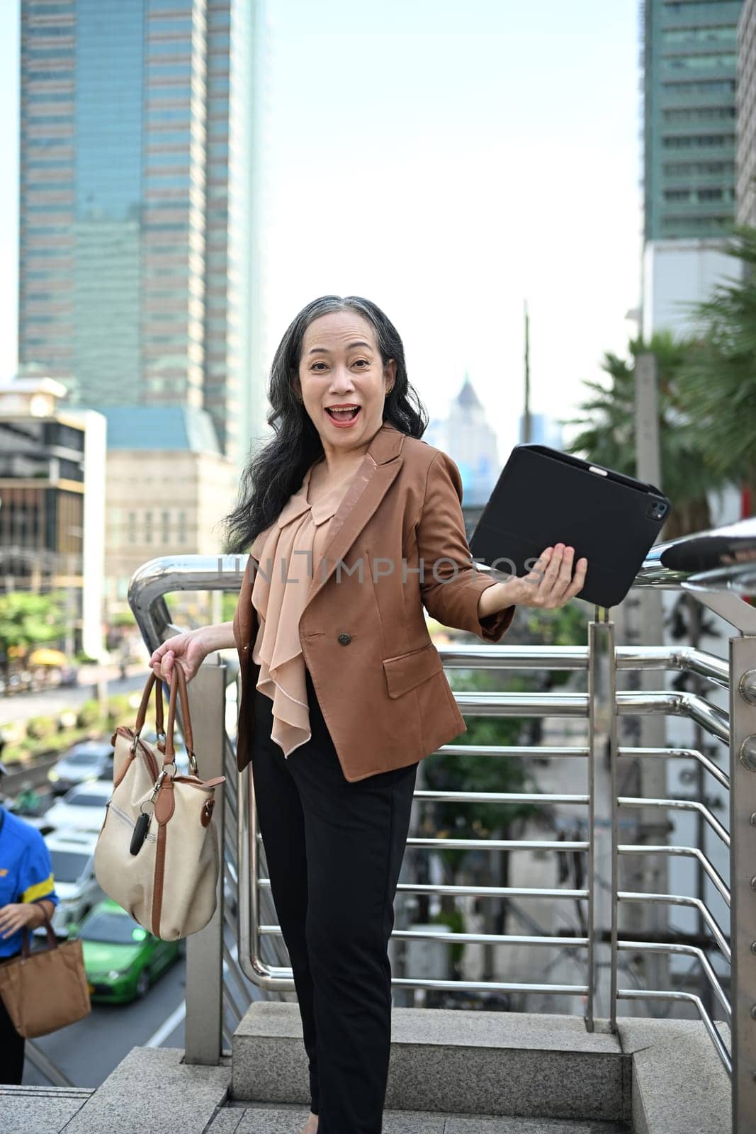 Cheerful senior businesswoman enjoying the city vibes.