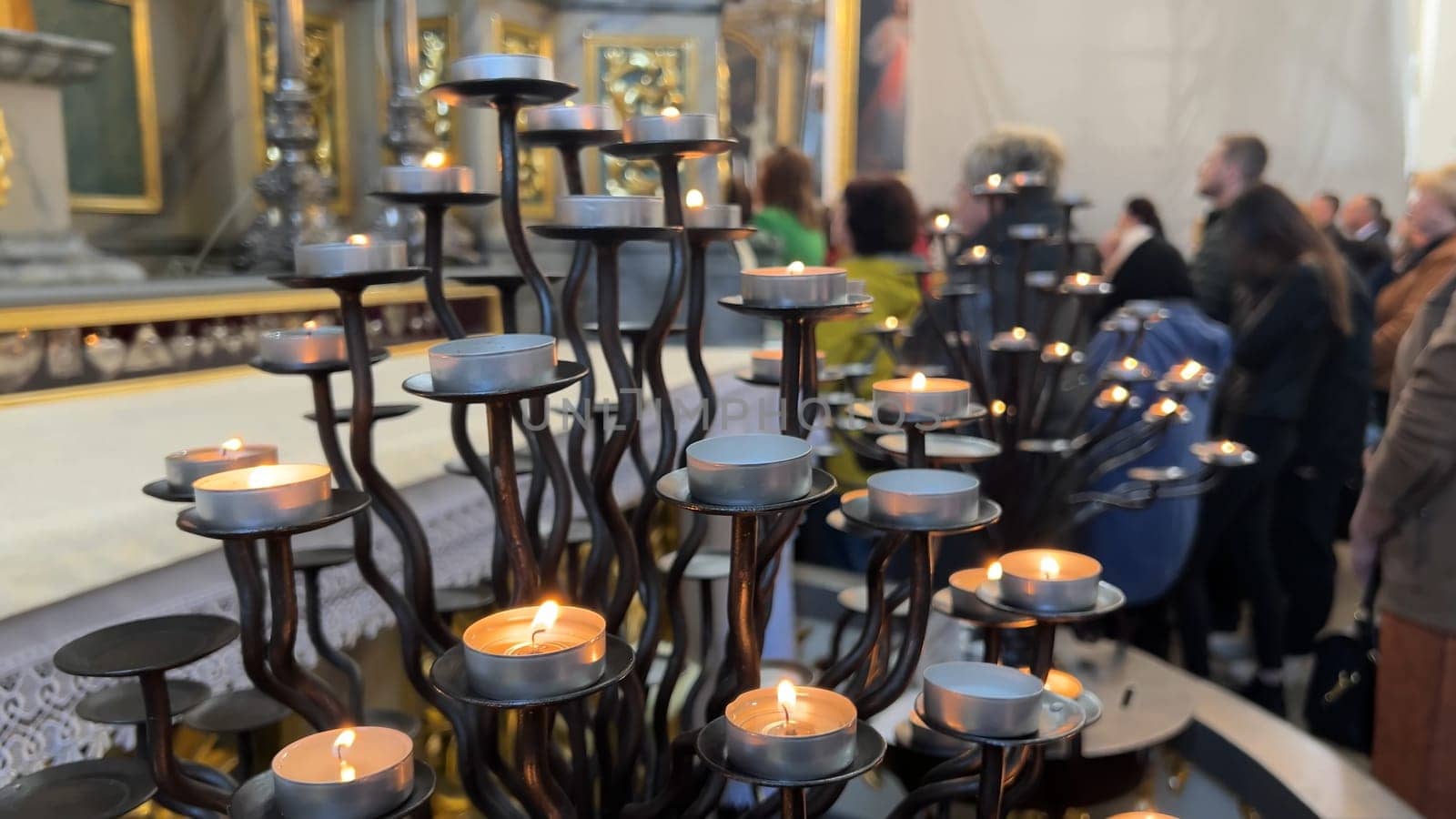 Burning candles in a Catholic church during the Divine Service