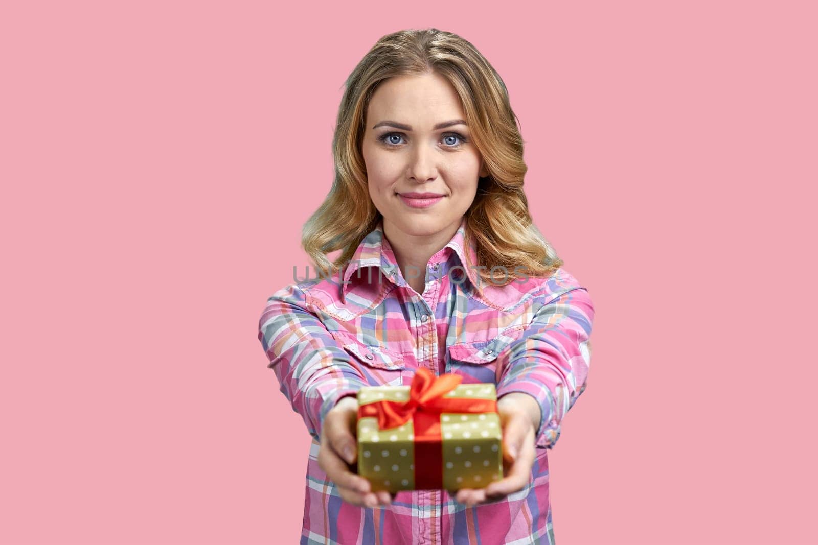 Attractive young blond woman giving a gift box. by super_picture