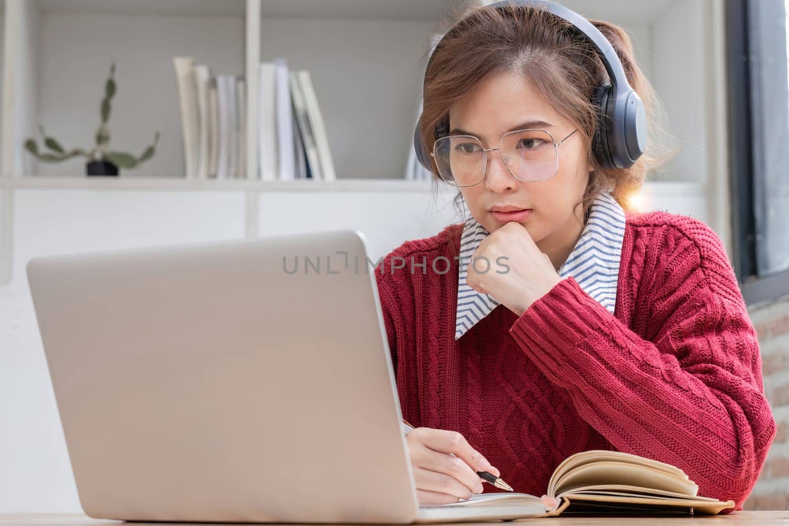 young woman studying online on laptop at home..