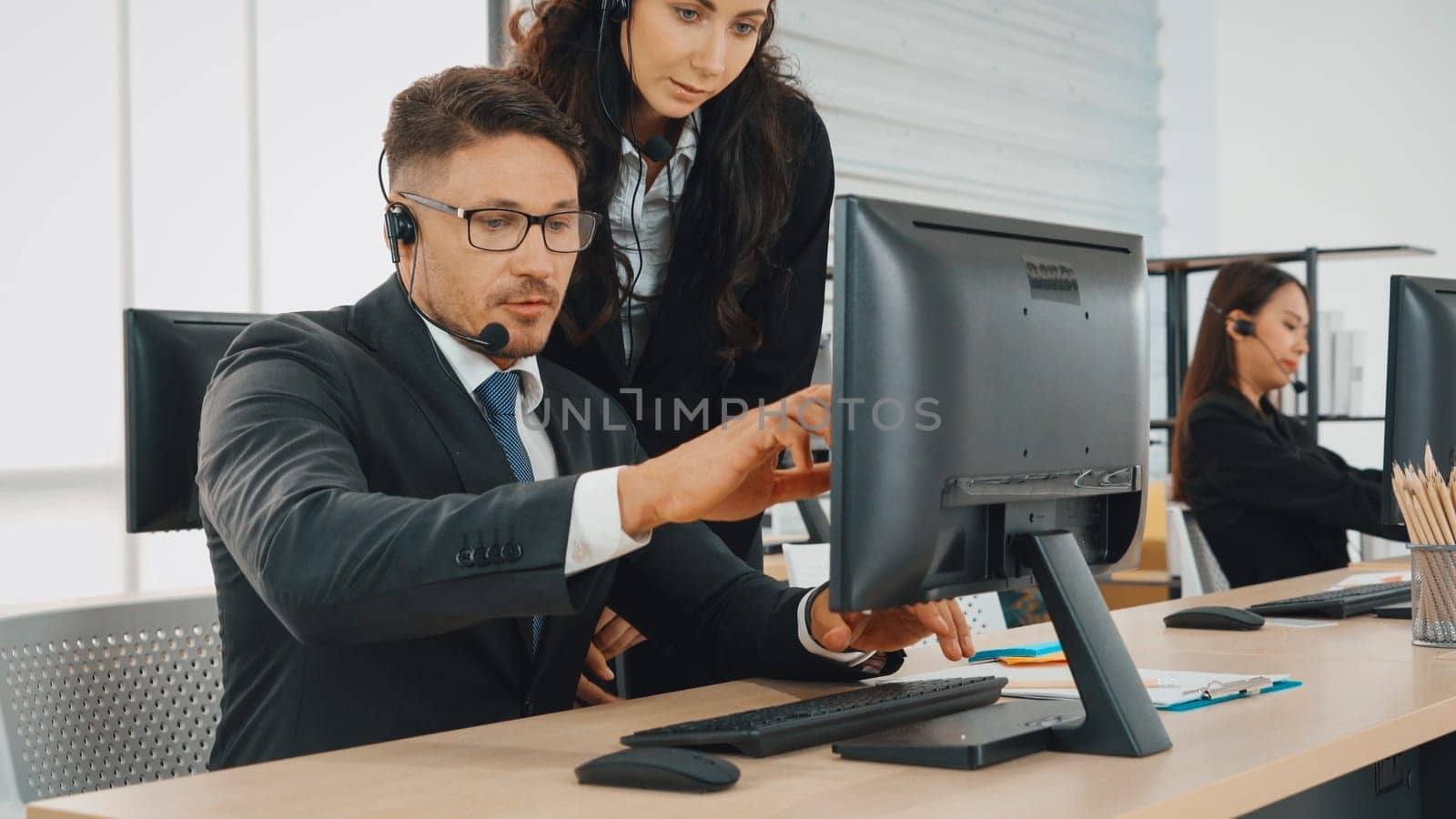 Business people wearing headset working in office Jivy by biancoblue