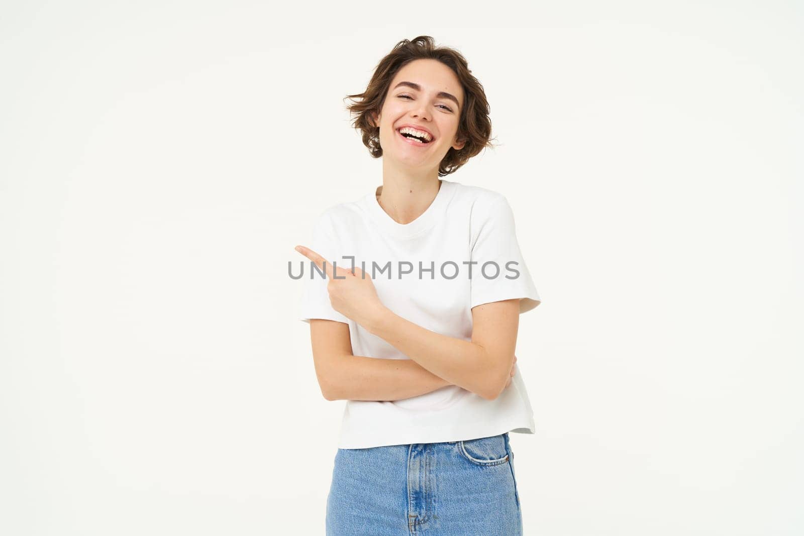 Image of excited woman, pointing finger left, showing advertisement, demonstrating brand banner, standing over white background.