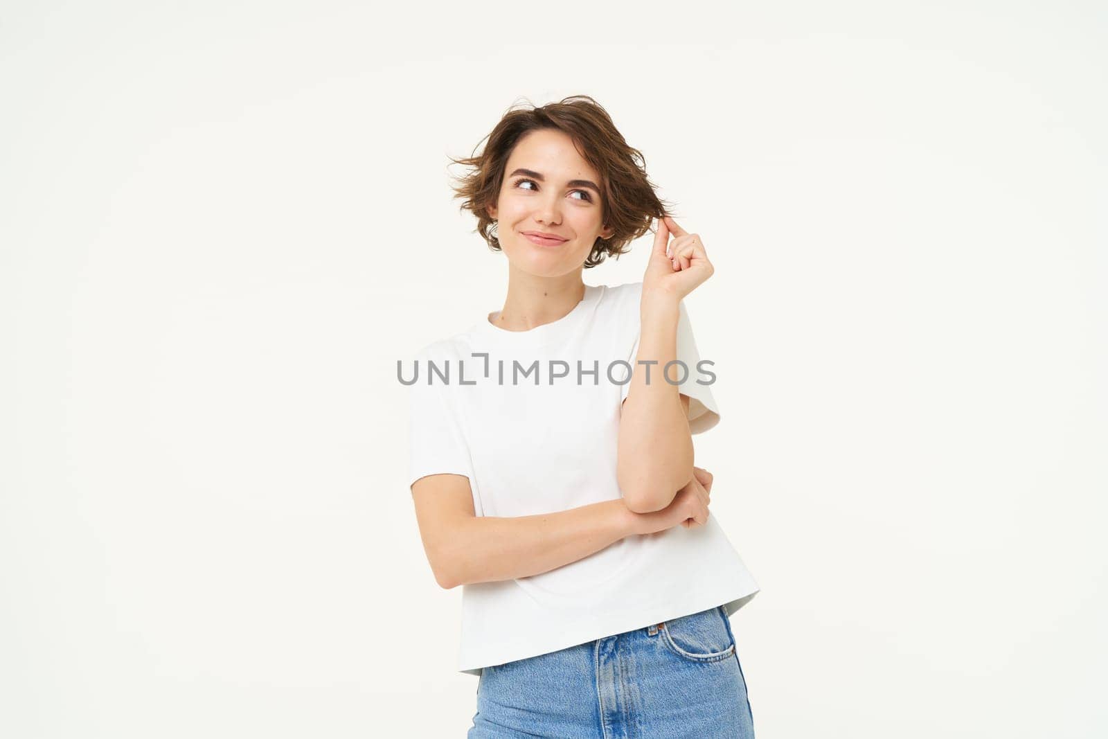 Portrait of carefree woman laughing, posing with confidence, looking self-assured and smiling, standing over white background. copy space