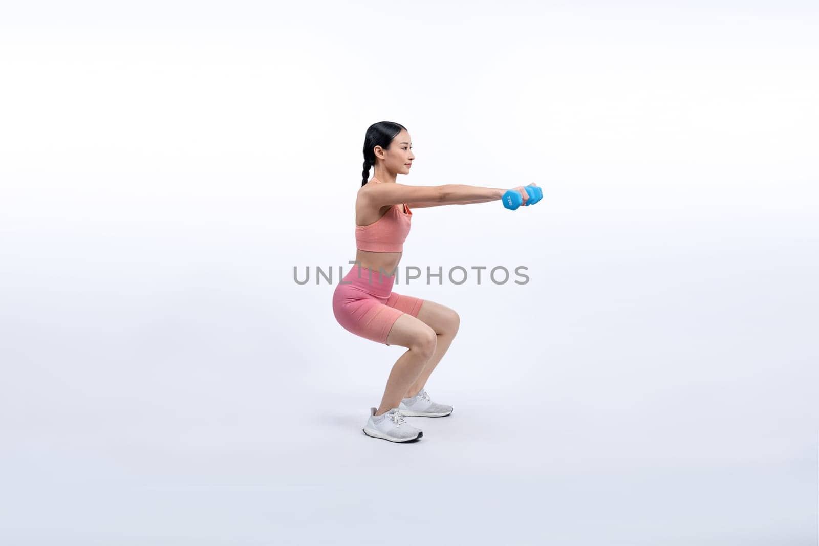 Vigorous energetic woman doing yoga with dumbbell weight exercise. by biancoblue