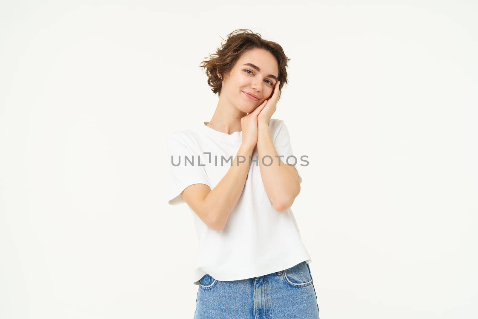 Portrait of cute, silly young woman, look with admiration, gazing at something, standing over white background.