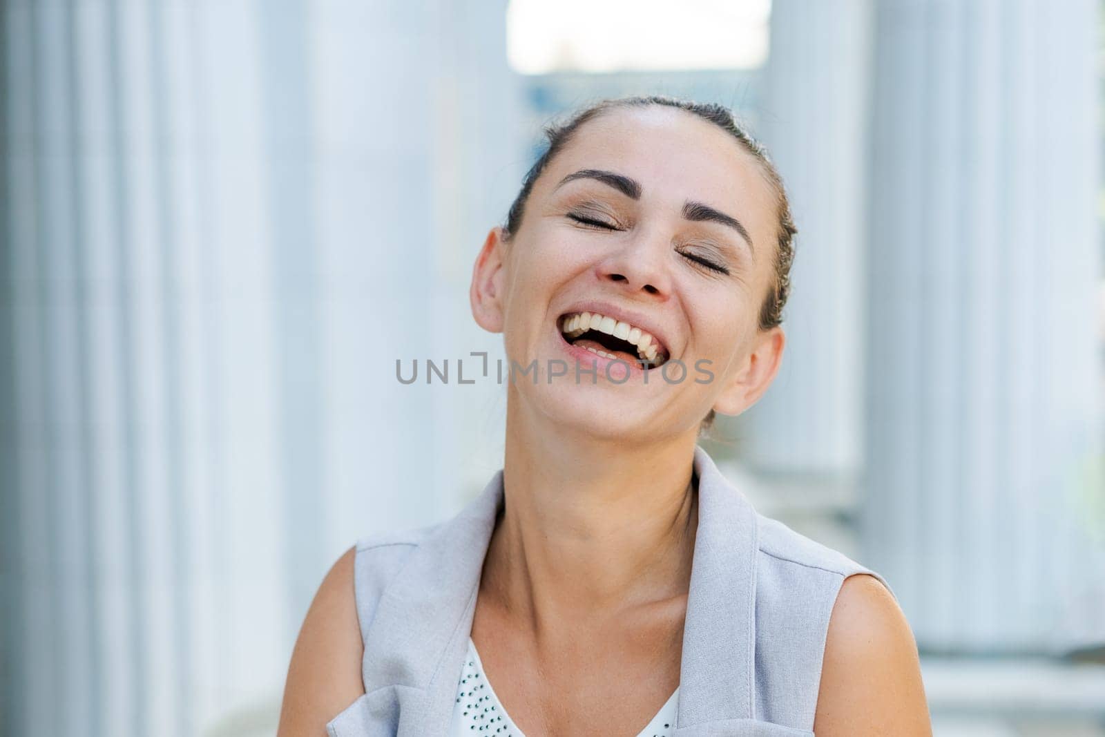 happy business woman laughing near the building, success concept
