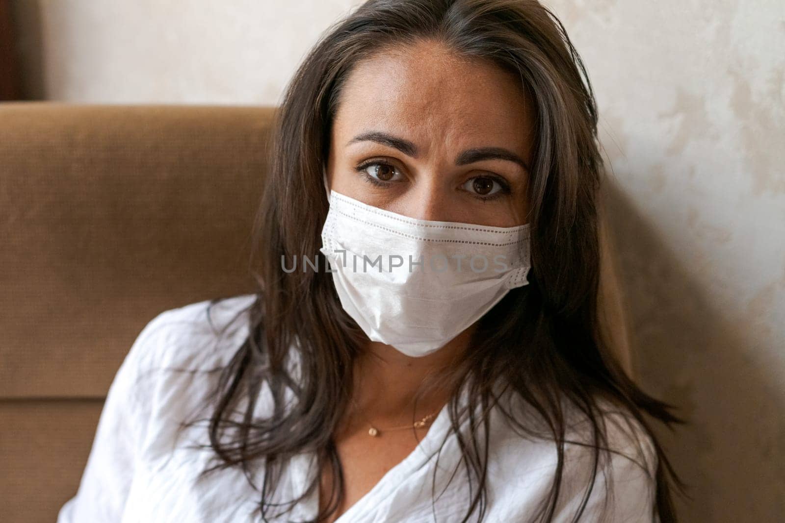 woman sitting on a chair with a protective mask , lifestyle concept by EkaterinaPereslavtseva