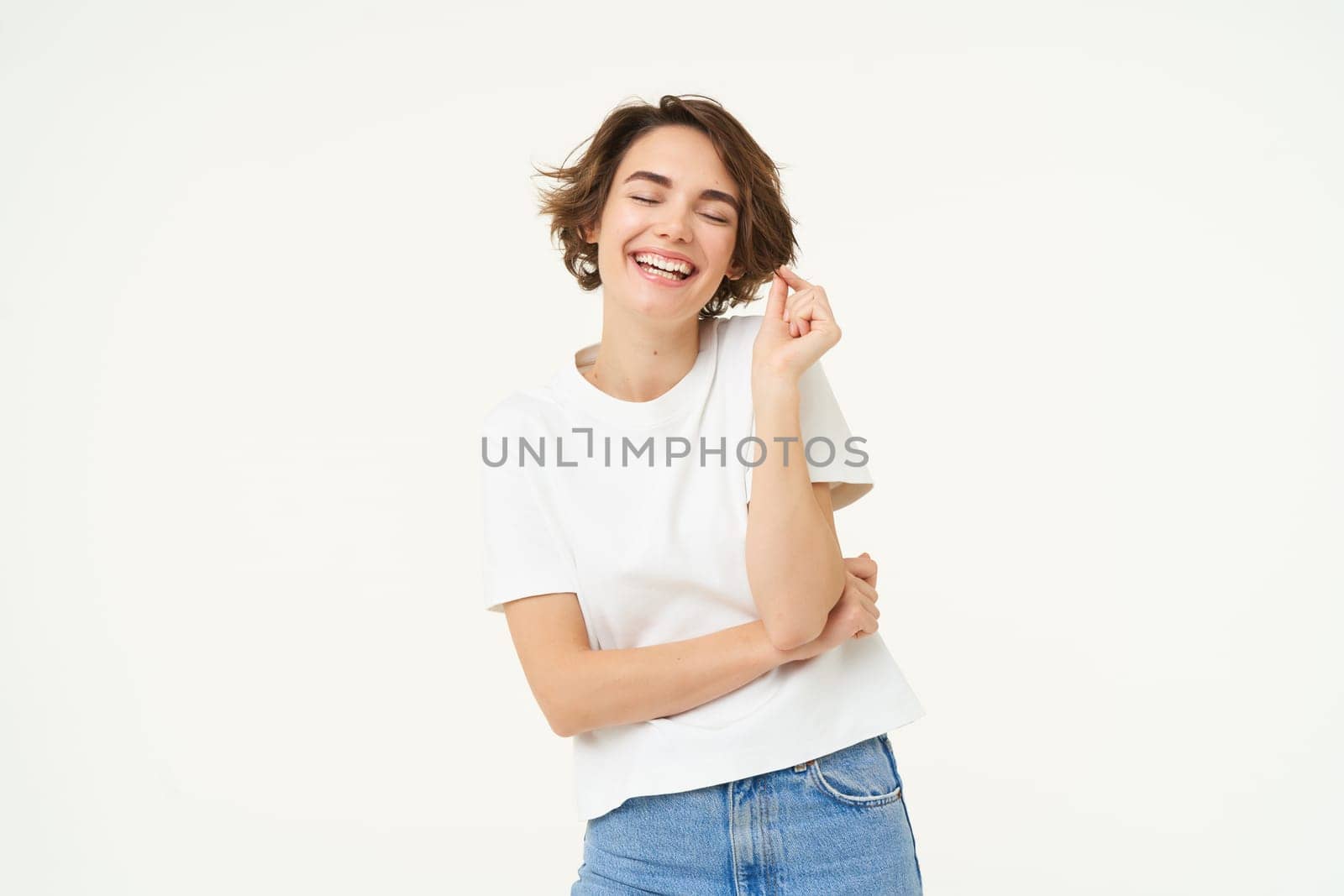 Portrait of cute brunette woman with confident smile, cross arms on chest, being self-assured, standing isolated over white background.