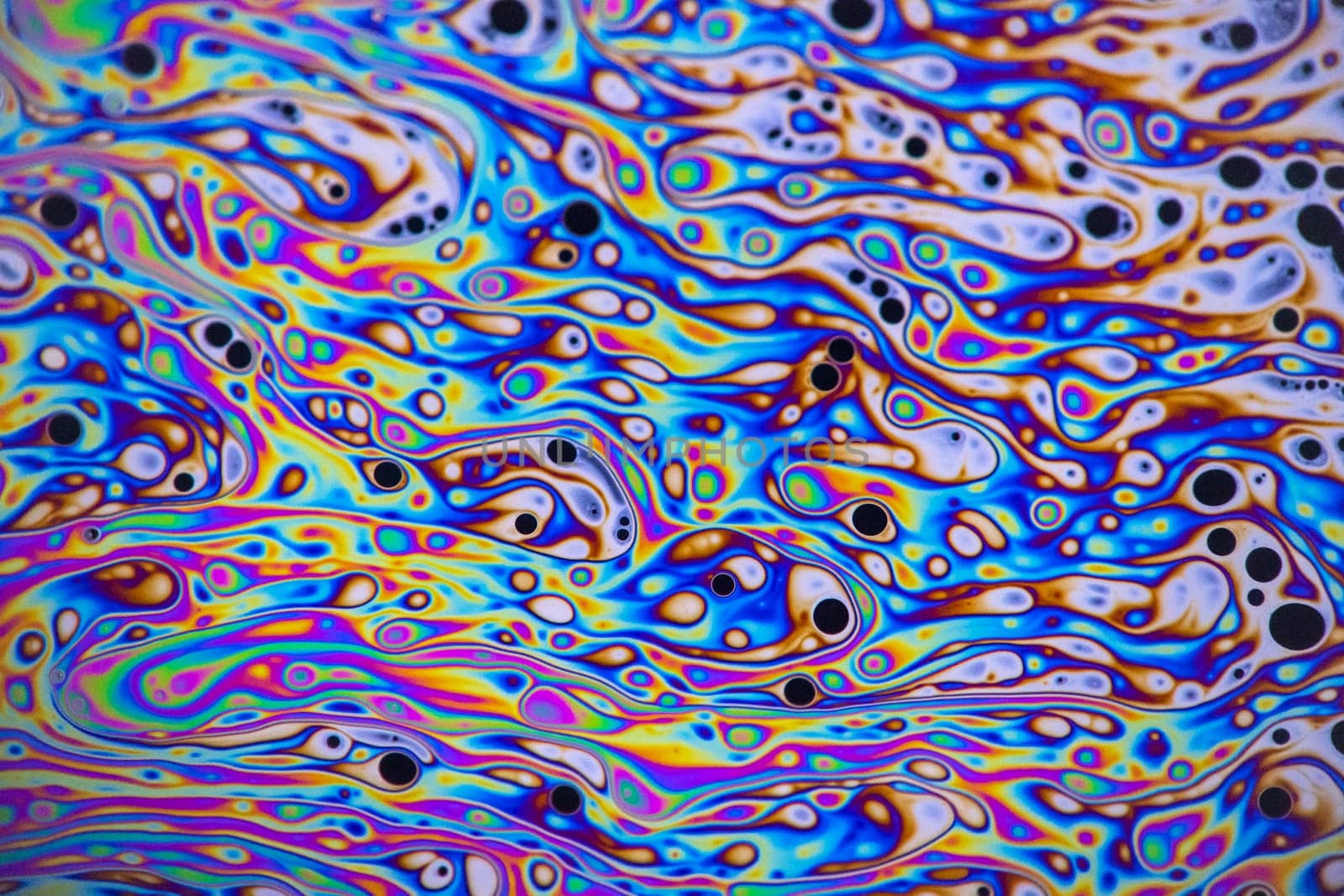 Macro photo of colourful pastel swirly patterns of a soap bubble by StefanMal