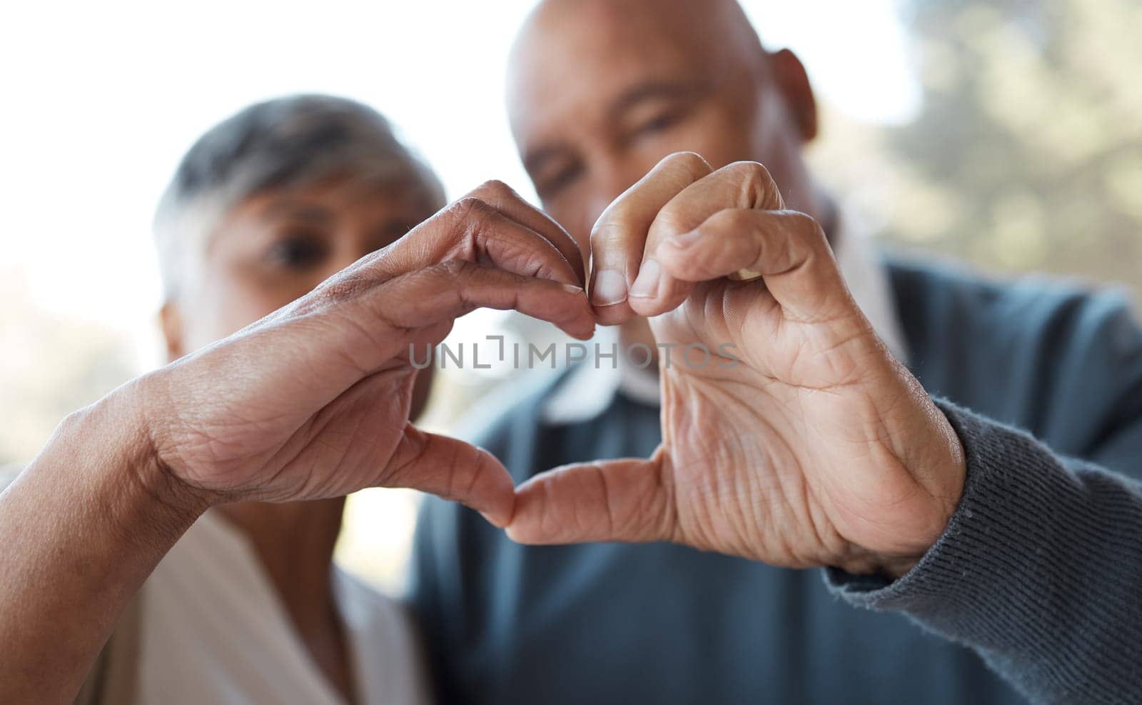 Marriage, heart hands and senior couple with care, romance and romance with bonding, relationship and retirement. Face, old woman and elderly man with love symbol, kindness and health with trust.