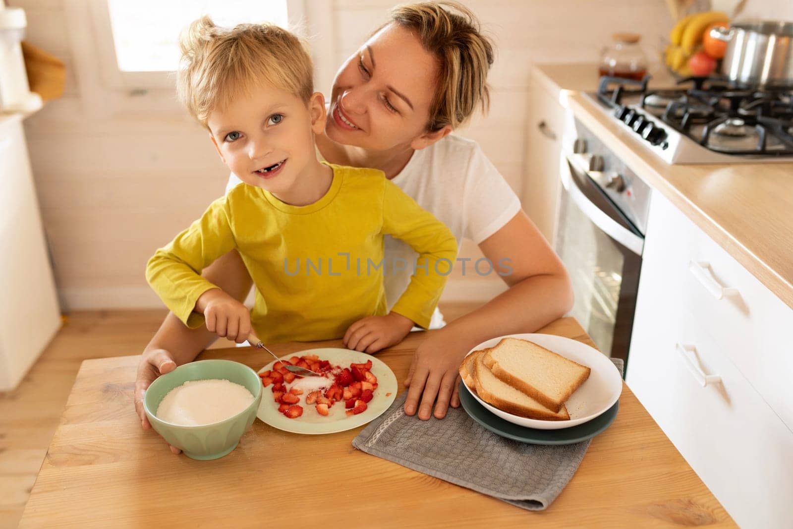 lifestyle concept, young mother and son spending time together at breakfast by TRMK