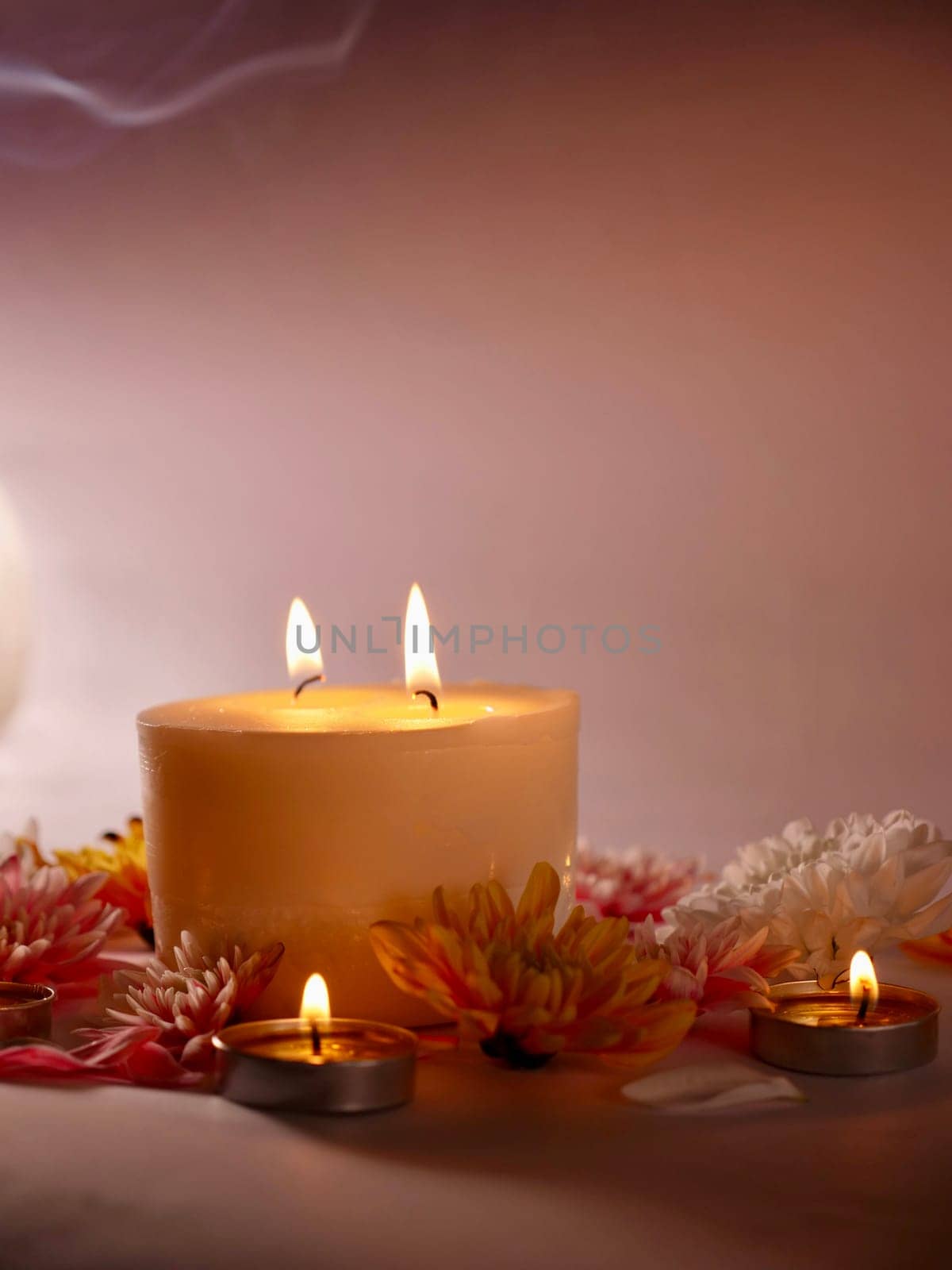 Celebration of Diwali or Deepavali holiday in India with candles and flowers in the evening at night close-up. Hindus celebrate the festival of lights, vertical