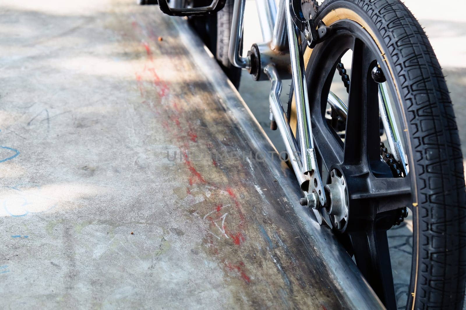 Close up of bmx bike on a ramp in a skatepark, BMX concept.