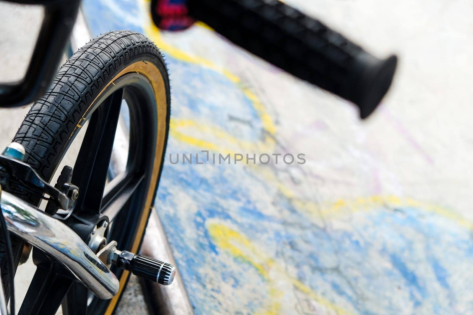 Close up of bmx bike on a ramp in a skatepark, BMX concept.