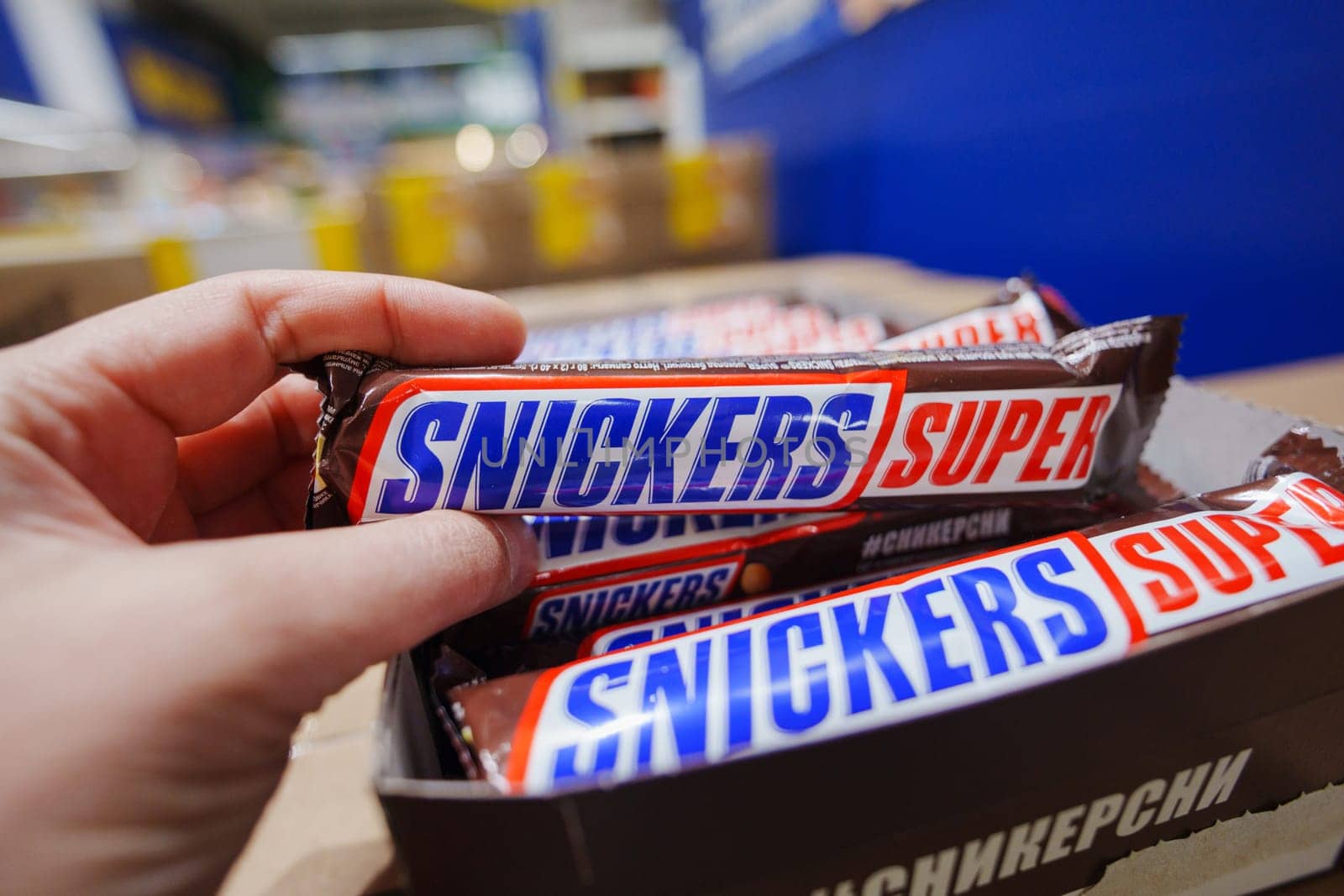 Tyumen, Russia-November 02, 2024: Snickers chocolate bar. Snickers bars are produced by Mars Incorporated.