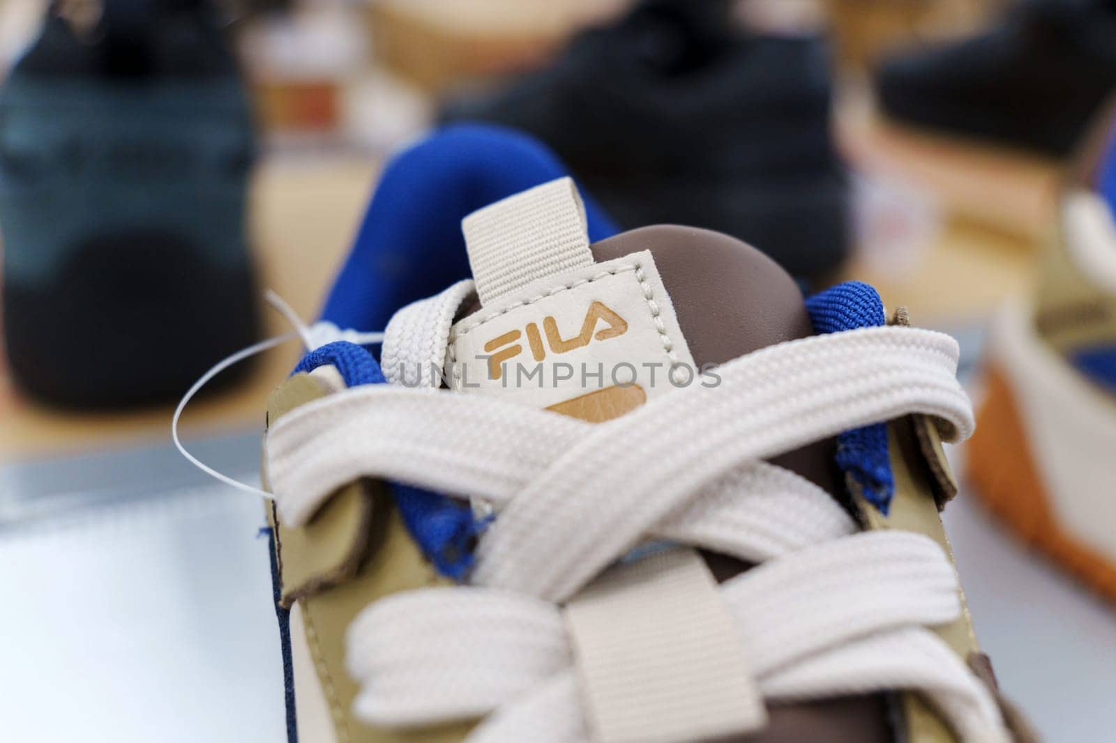 Tyumen, Russia-August 11, 2024: Fila sneaker is prominently displayed with detailed lacing and a visible brand tag, viewed inside a retail shop.