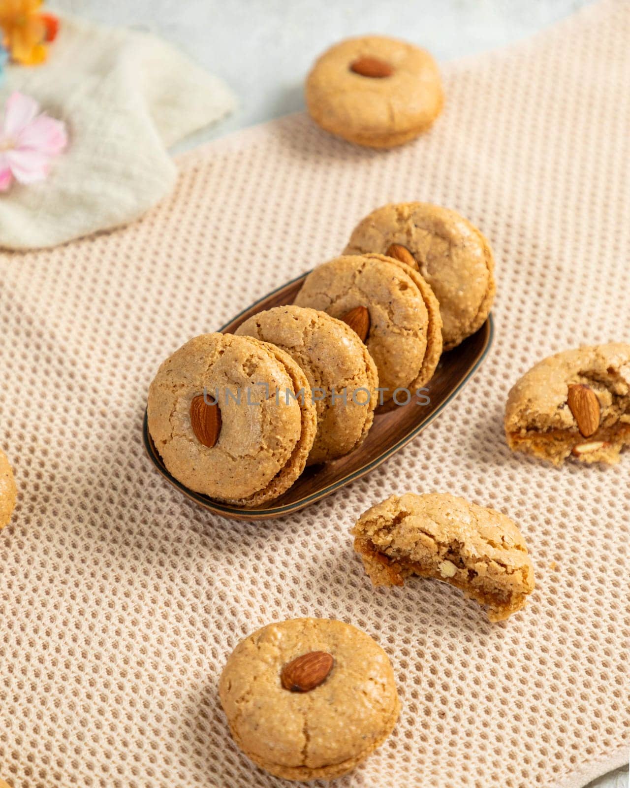 Delicious homemade almond cookies with a crunchy texture resting on a beige tablecloth