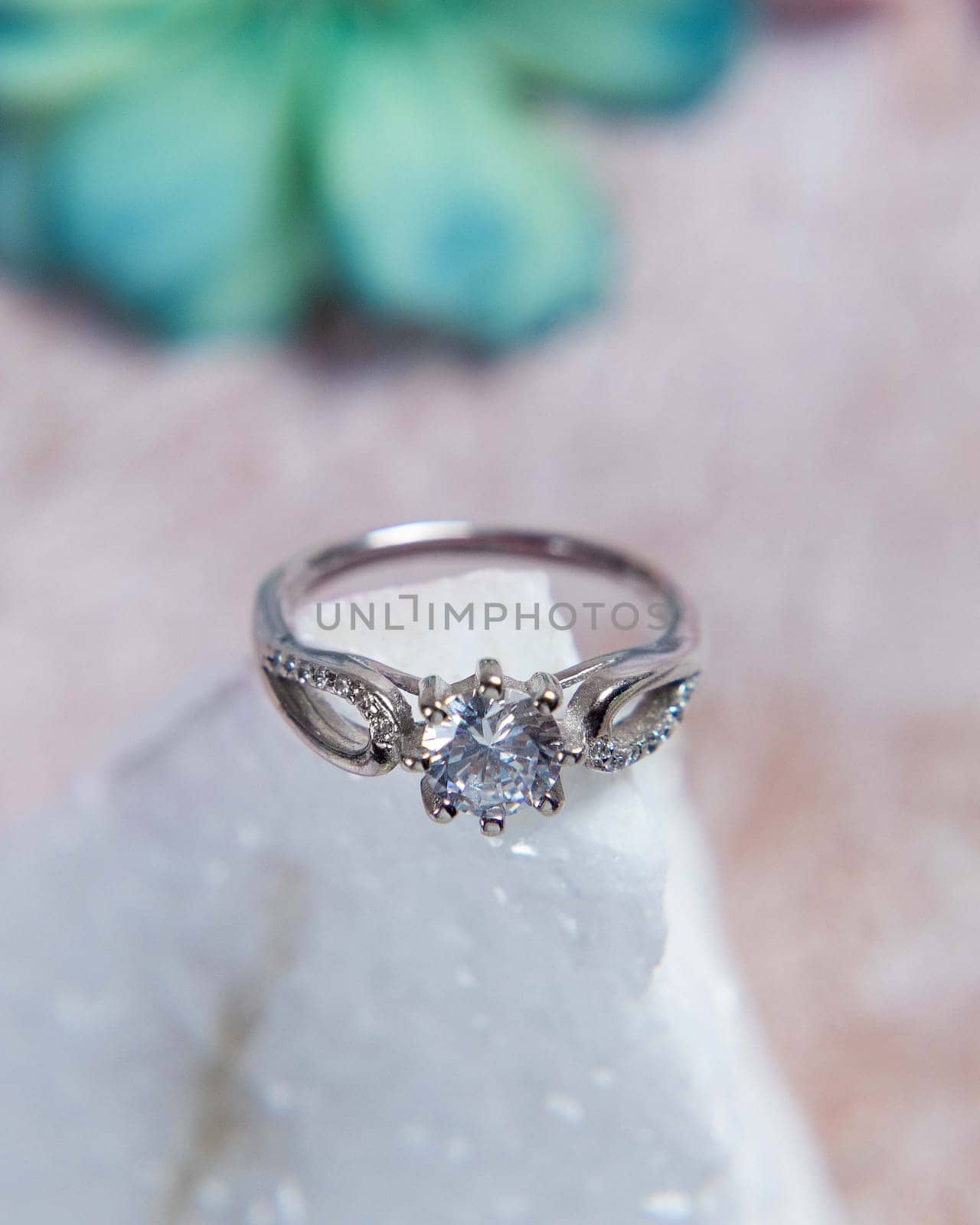 Silver ring with big diamond sparkling on white stone is perfect as a gift for valentine's day or wedding