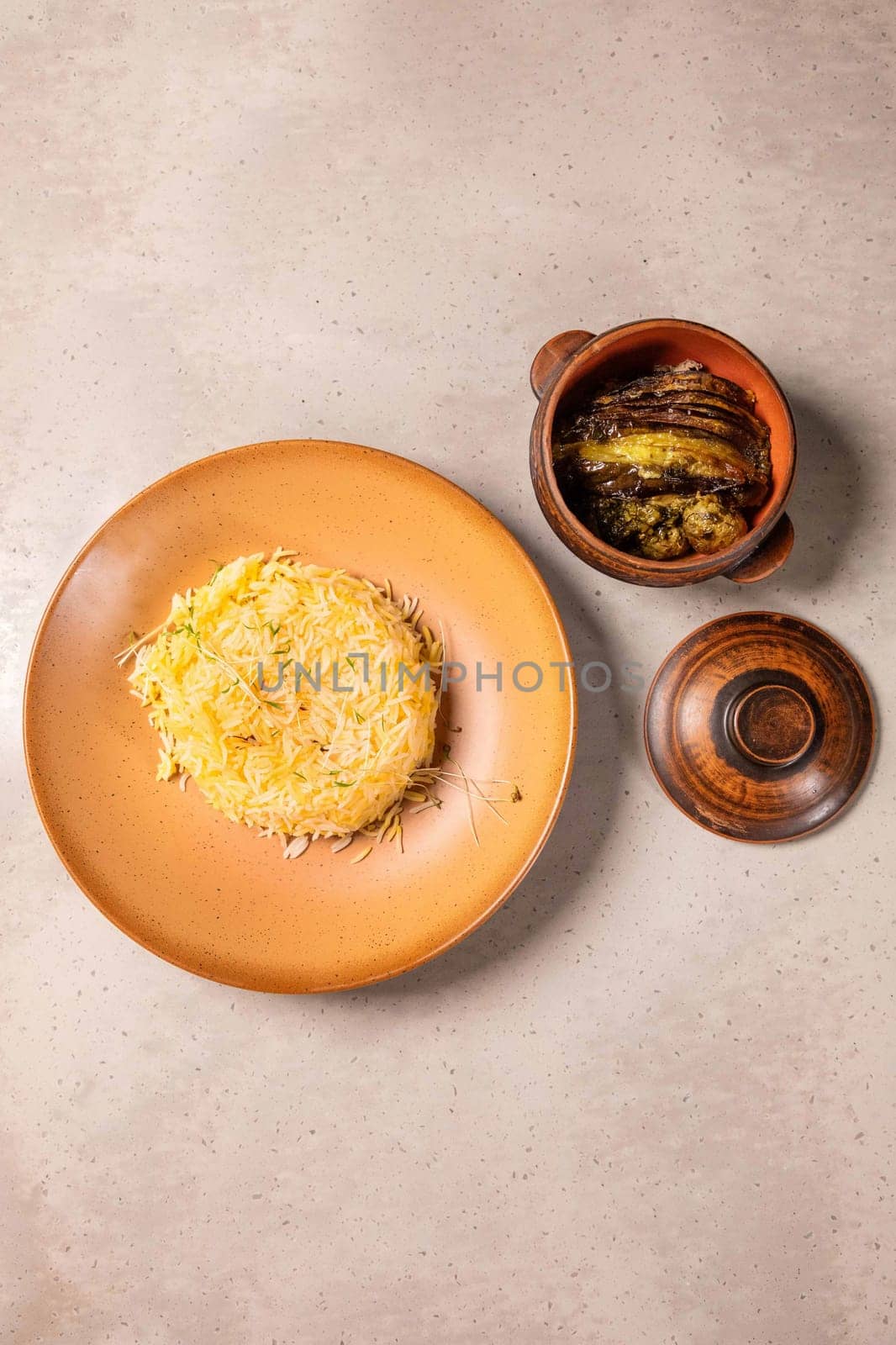 Saffron rice and eggplant dish served on ceramic plates over a light background