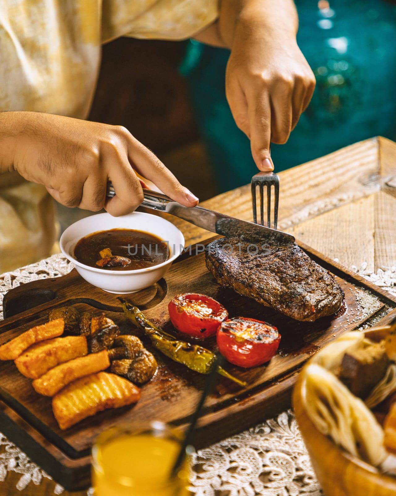 Woman enjoying a dinner of grilled beef steak with vegetables and gravy