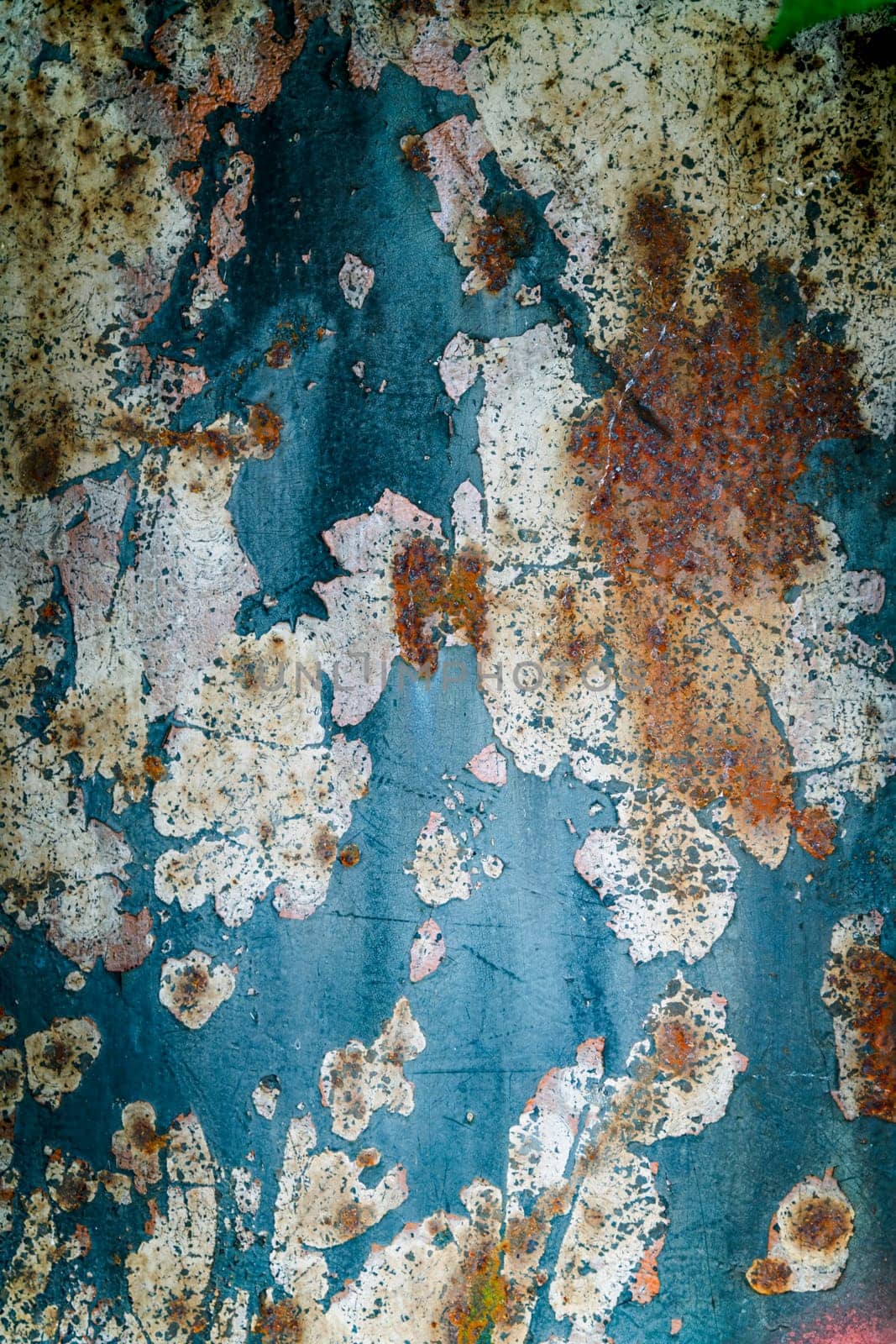An abstract depiction macro of rusted metal featuring peeling paint with vibrant colors. Highlights complex textures and weathered surfaces, conveying a sense of decay and artistic expression