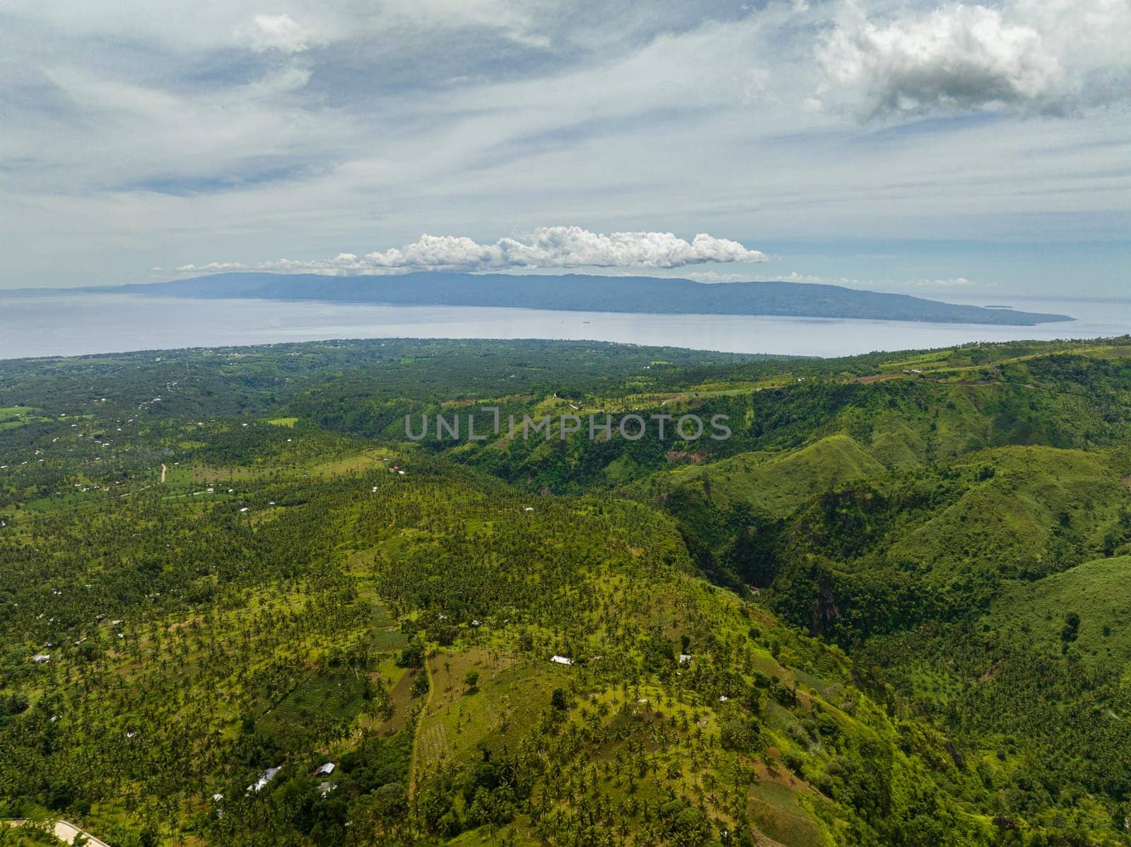 Aerial view of coastline of Negros Island with towns and farmland. Philippines.