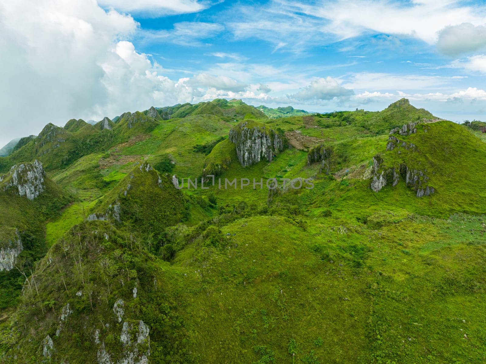 Aerial view of mountains and green hills among clouds and fog. Osmena Peak. Mountain landscape. Cebu Philippines.