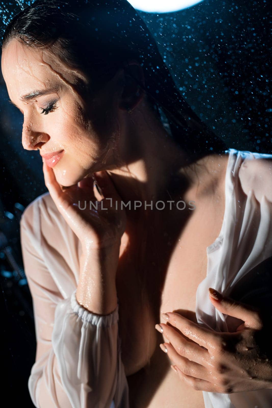 Gorgeous pregnant brunette wearing only a shirt portrait in a shower