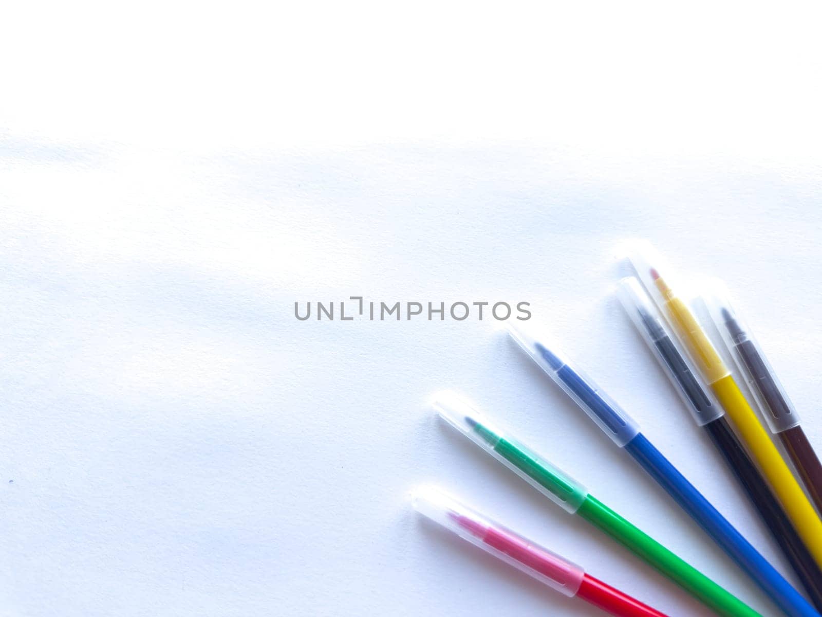 Colorful pens on white background for creative inspiration and office supplies.