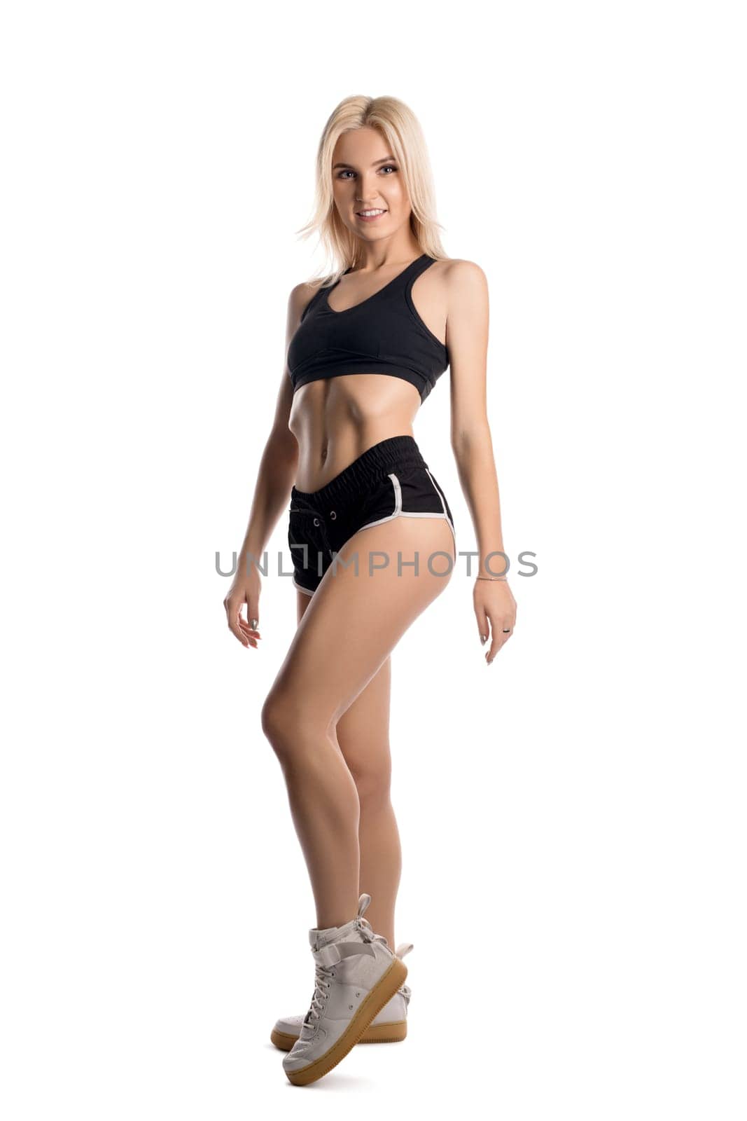 Slim fitness trainer in sportswear isolated full-length shot