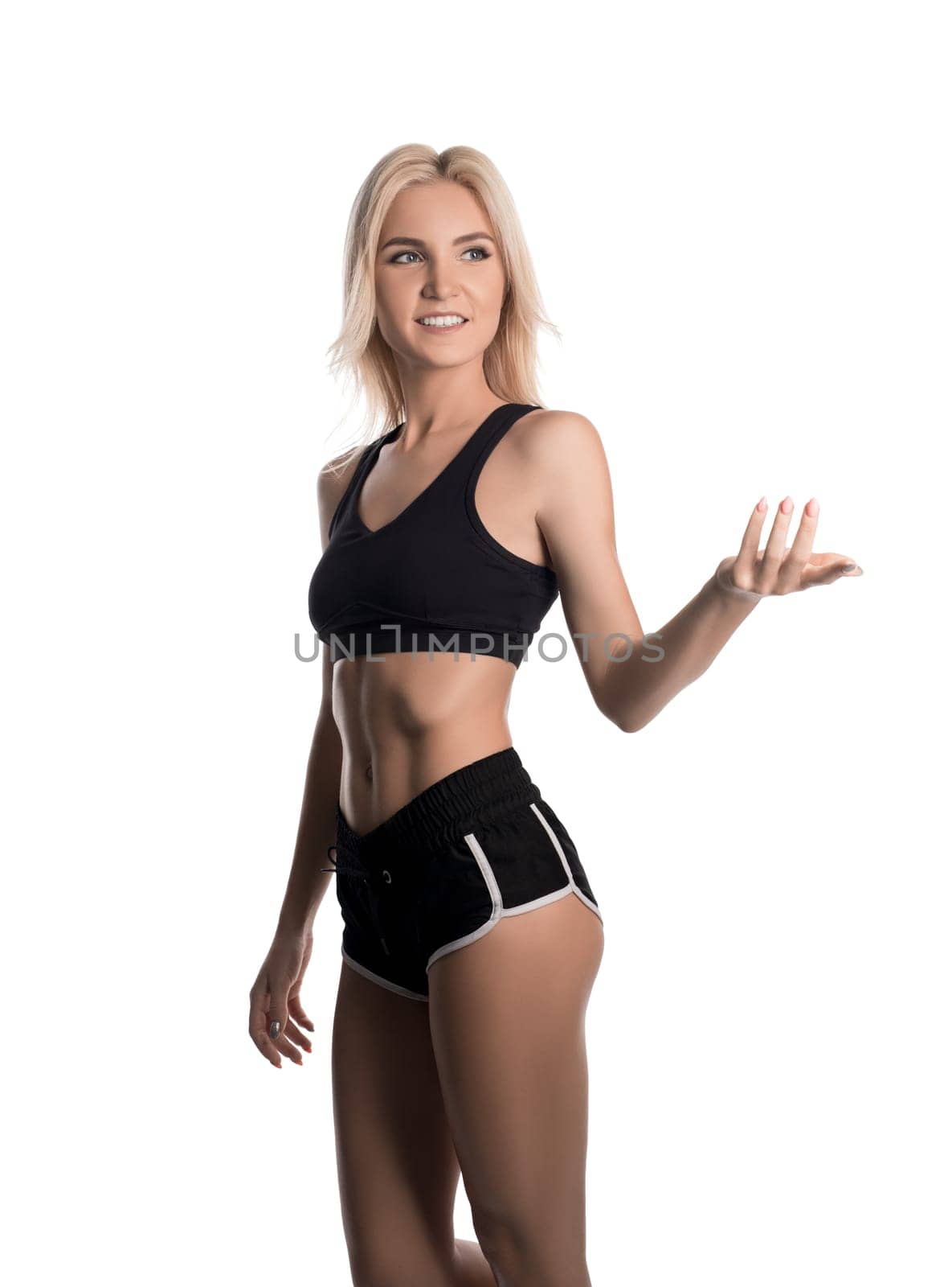Sporty slim blonde wearing sexy top and shorts isolated cropped view